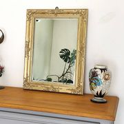 Miroir ancien doré richement sculpté