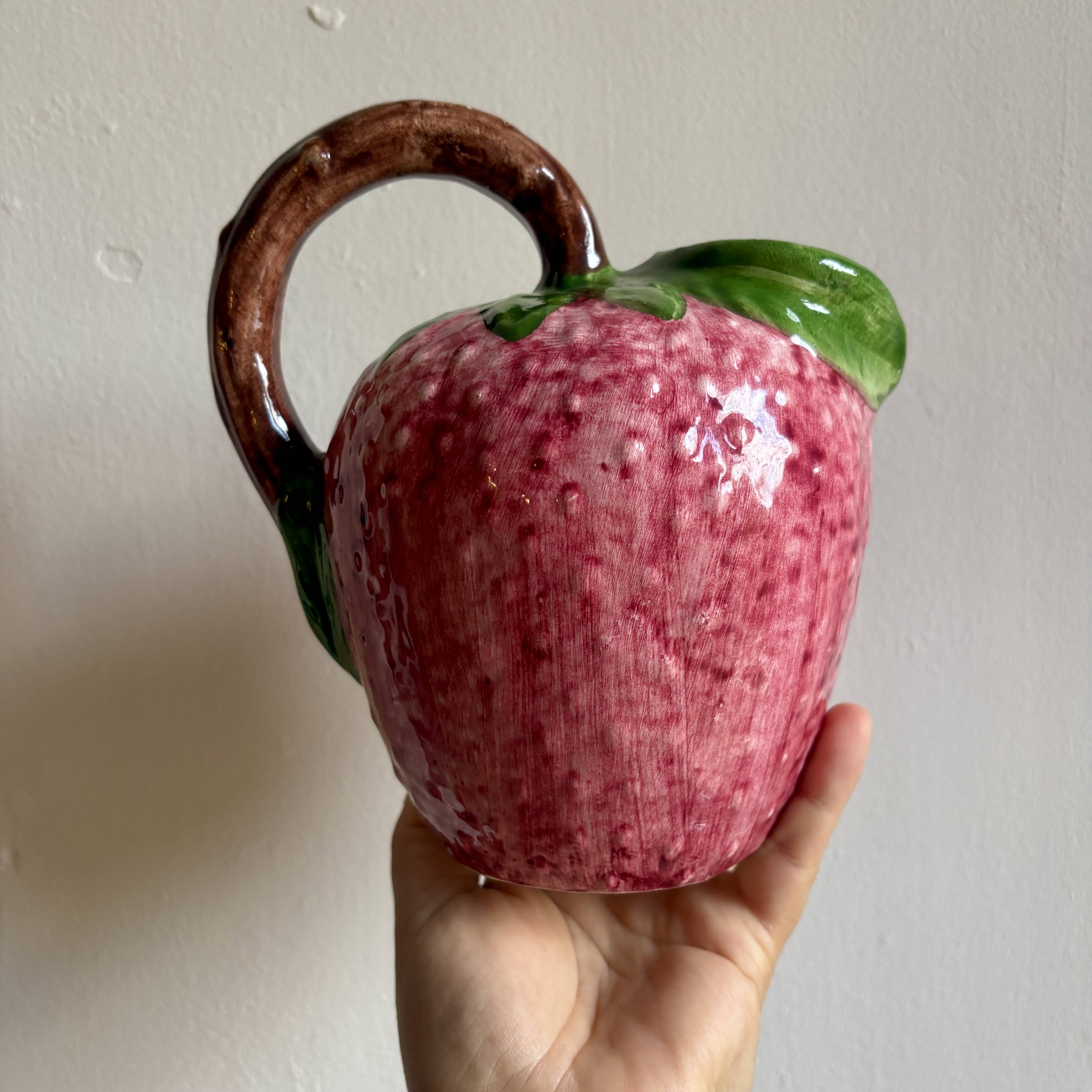 Ceramic jug in the shape of a strawberry.