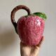Ceramic jug in the shape of a strawberry.
