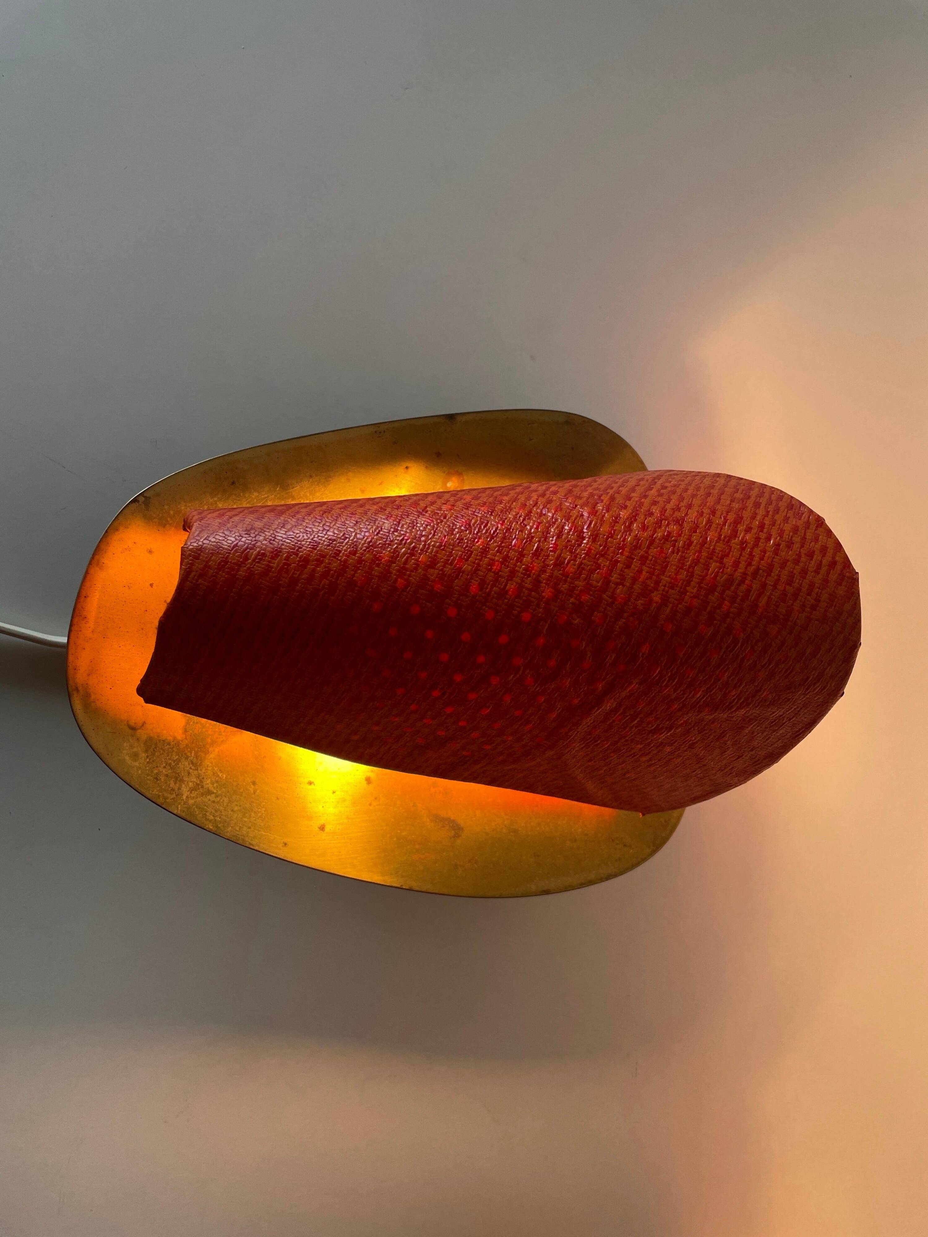 Pair of orange plexiglass and curved brass wall lights, 1950s, Germany