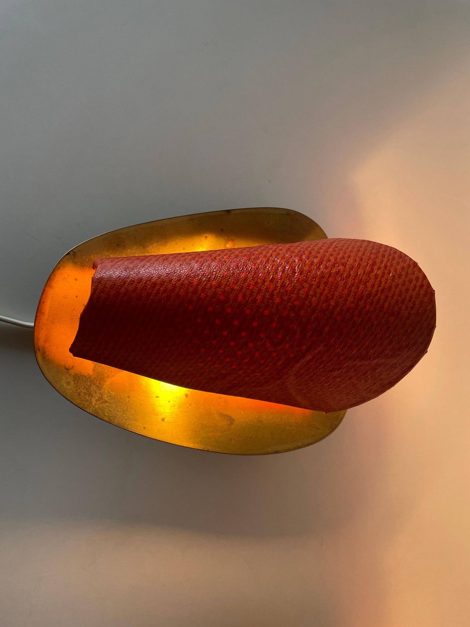 Pair of orange plexiglass and curved brass wall lights, 1950s, Germany