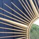 Miroir soleil Chaty Vallauris en métal doré