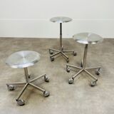 3 adjustable industrial stools with aluminum wheels