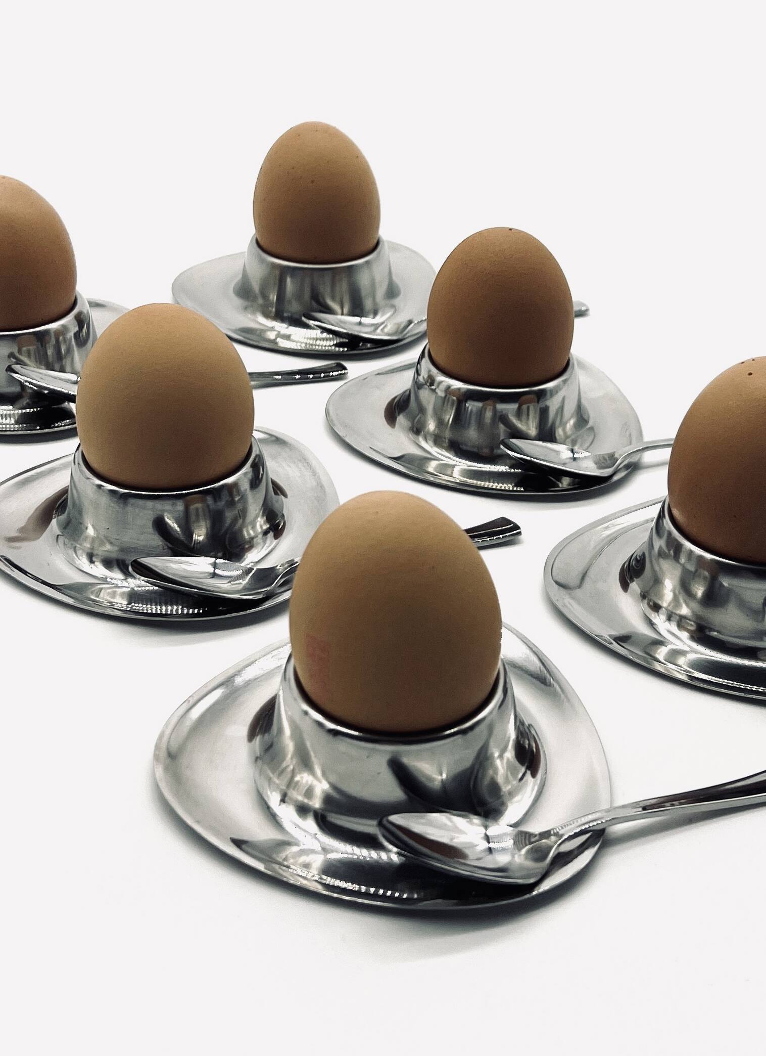 Six egg cups and six stainless steel spoons