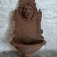 Old cast iron wall fountain with lion's head