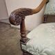 Antique Louis XIV style armchair in moulded wood and damask-style fabric.