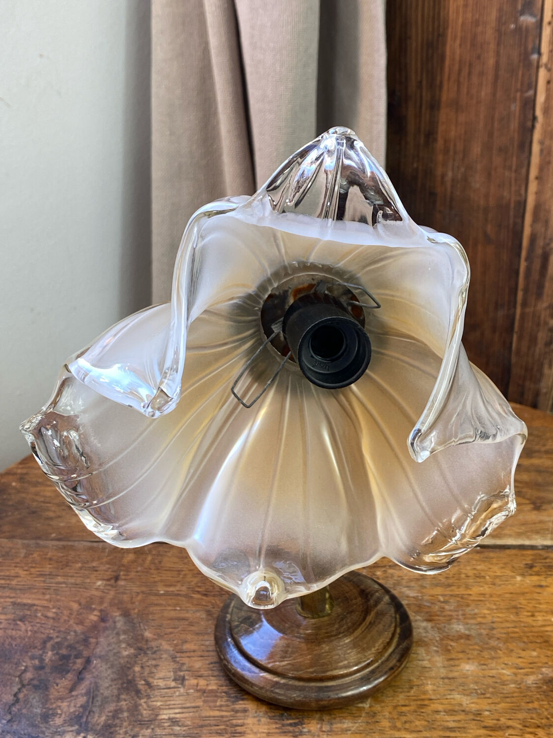 Bronze and glass wall light in the shape of a flower.