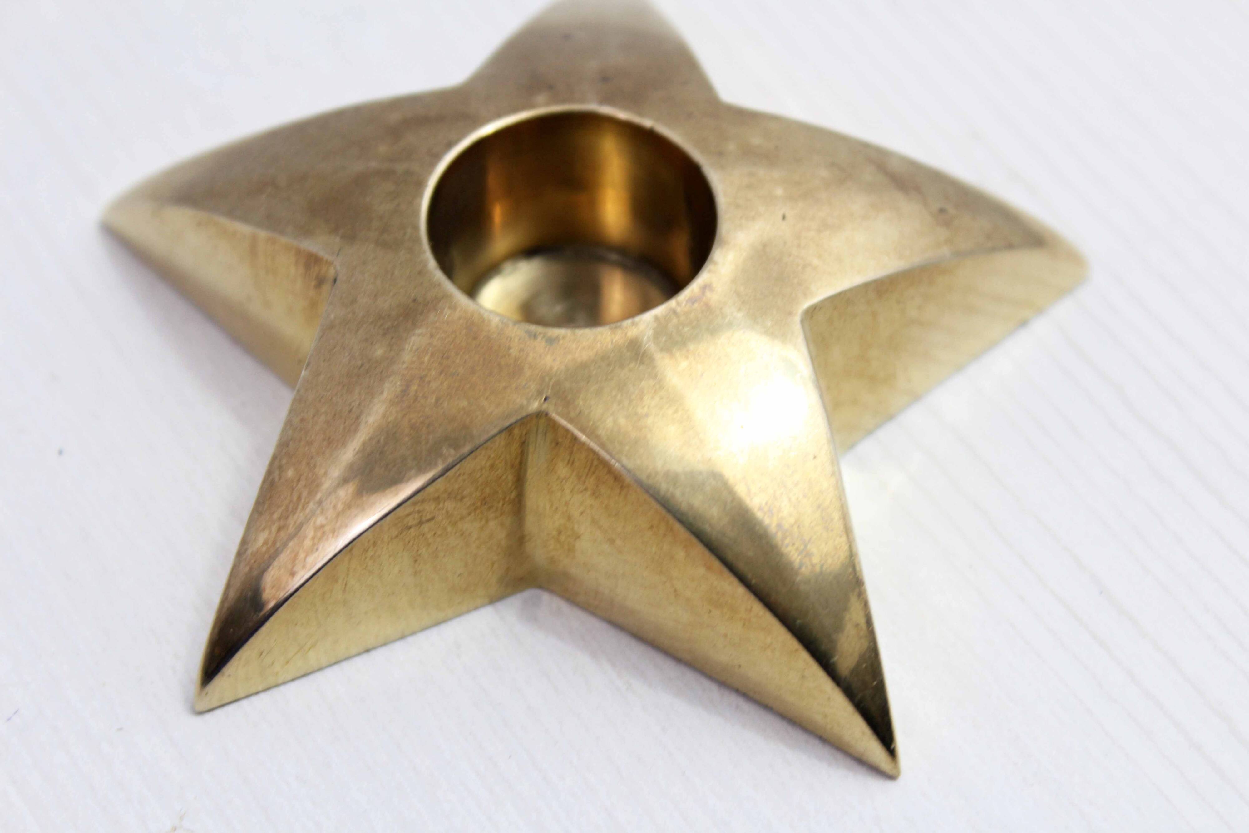 Star-shaped brass candle holder