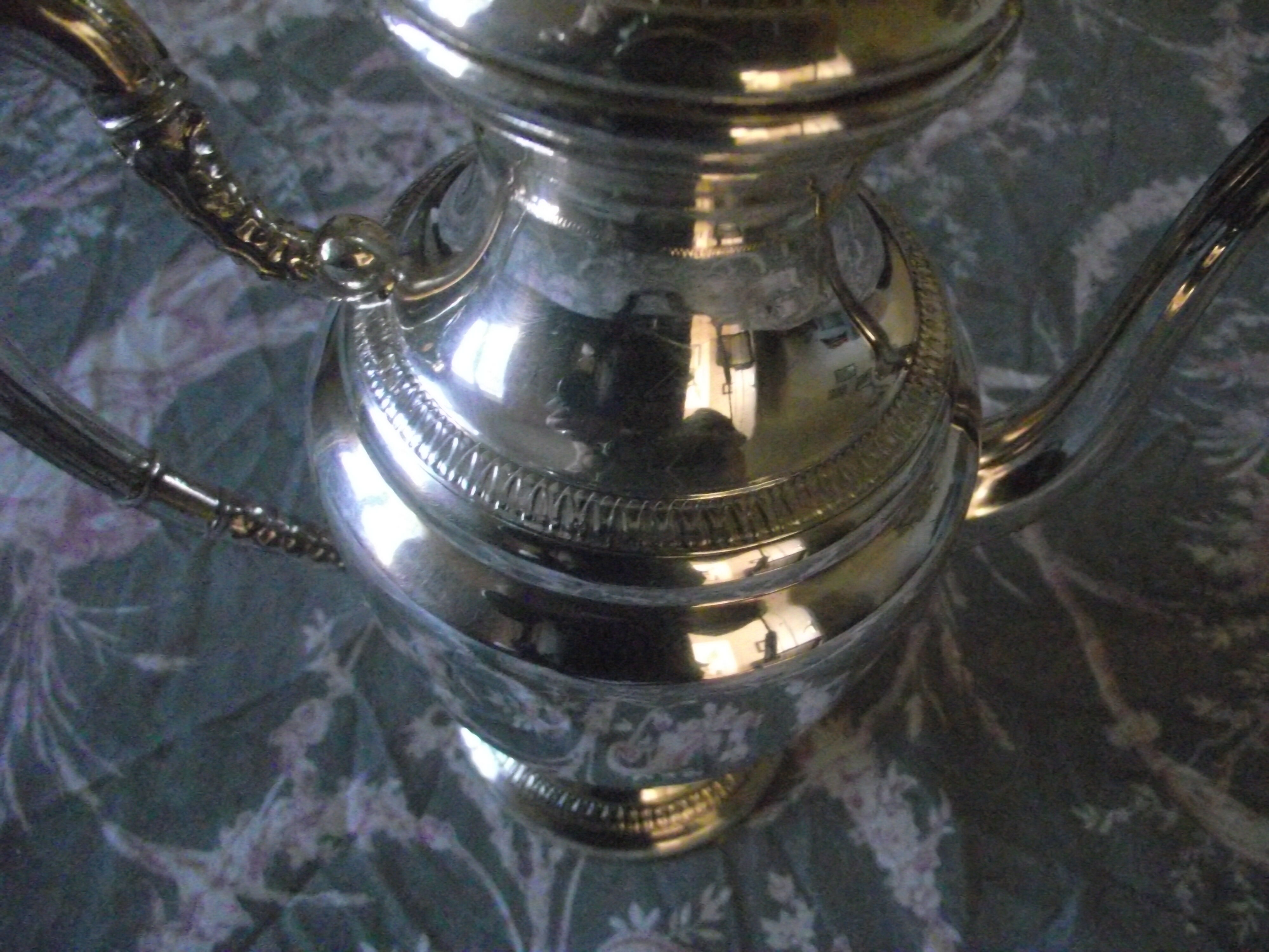 Empire-style silver metal teapot.