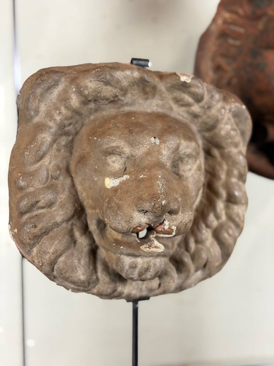 Three cast-iron and terracotta façade decoration lions, around 1880.