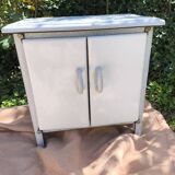 Small white and speckled gray industrial style enameled piece of furniture