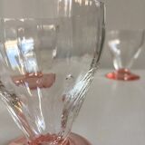Lot of water in white and pink glass glasses