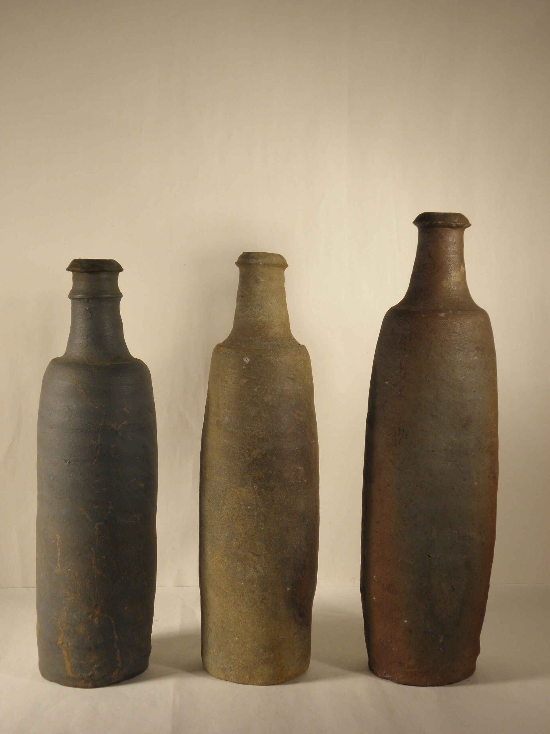 Three old sandstone bottles