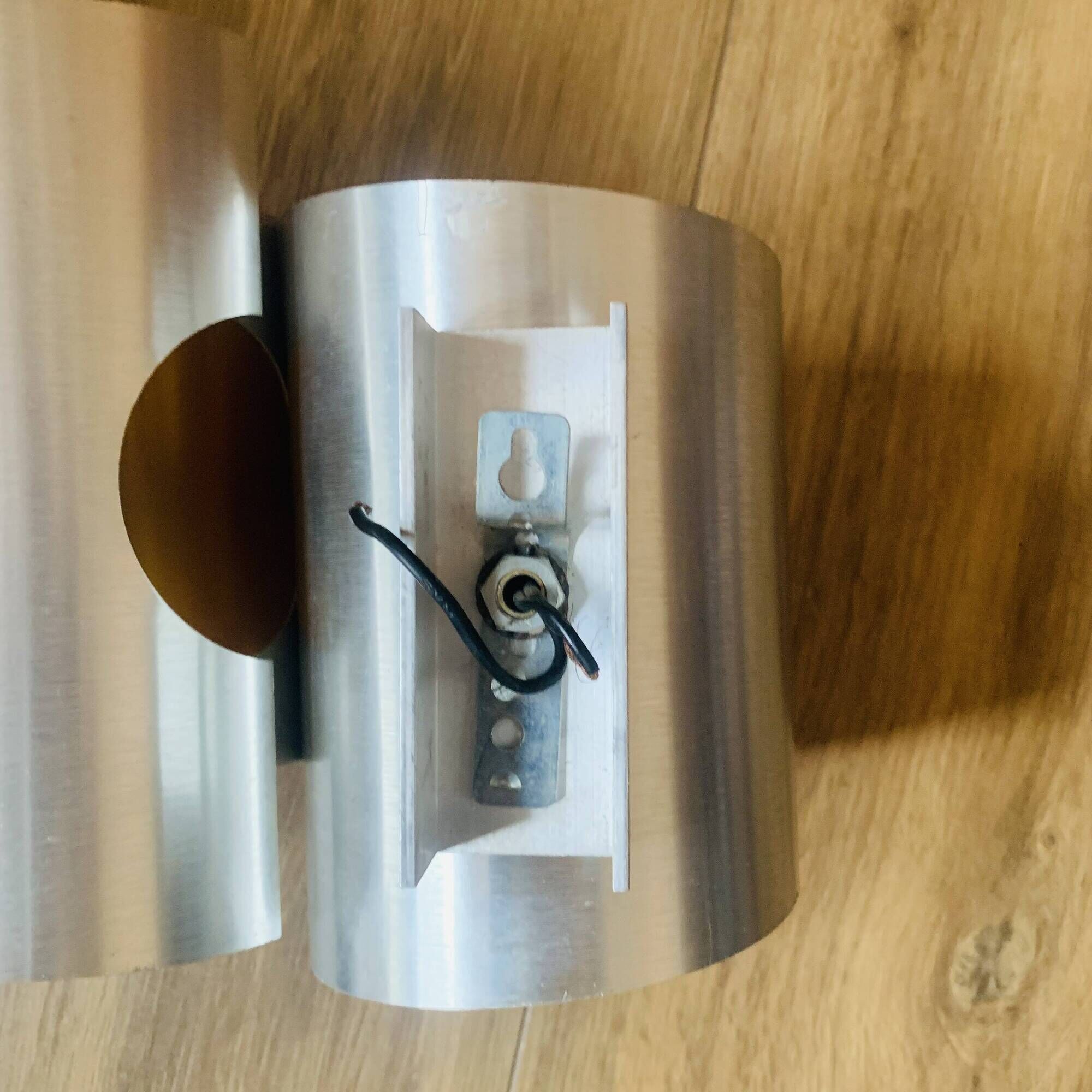 Pair of Space Age wall lights in brushed metal with a copper-orange interior.