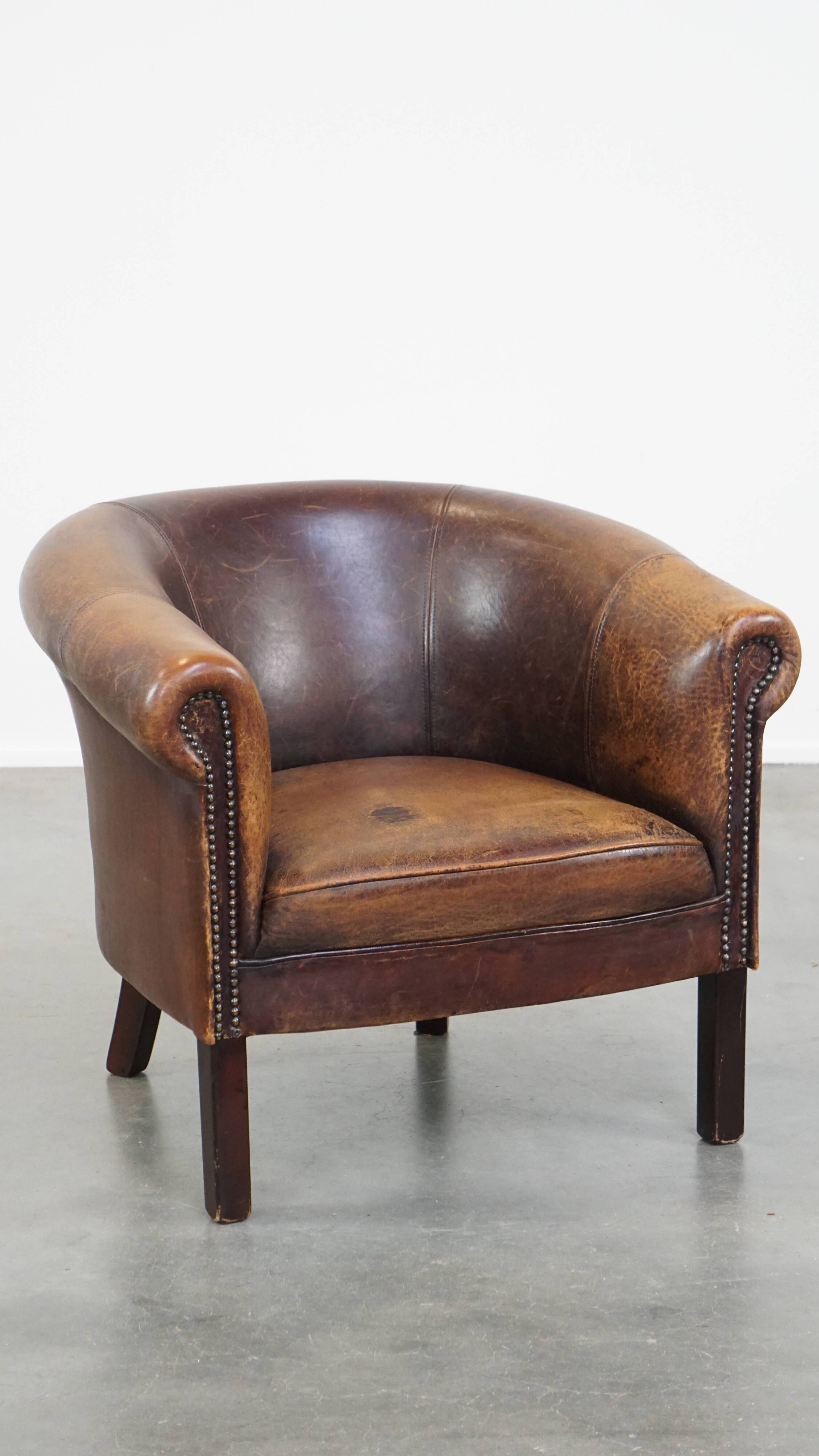 Sheep leather club chair finished with decorative nails