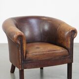 Sheep leather club chair finished with decorative nails