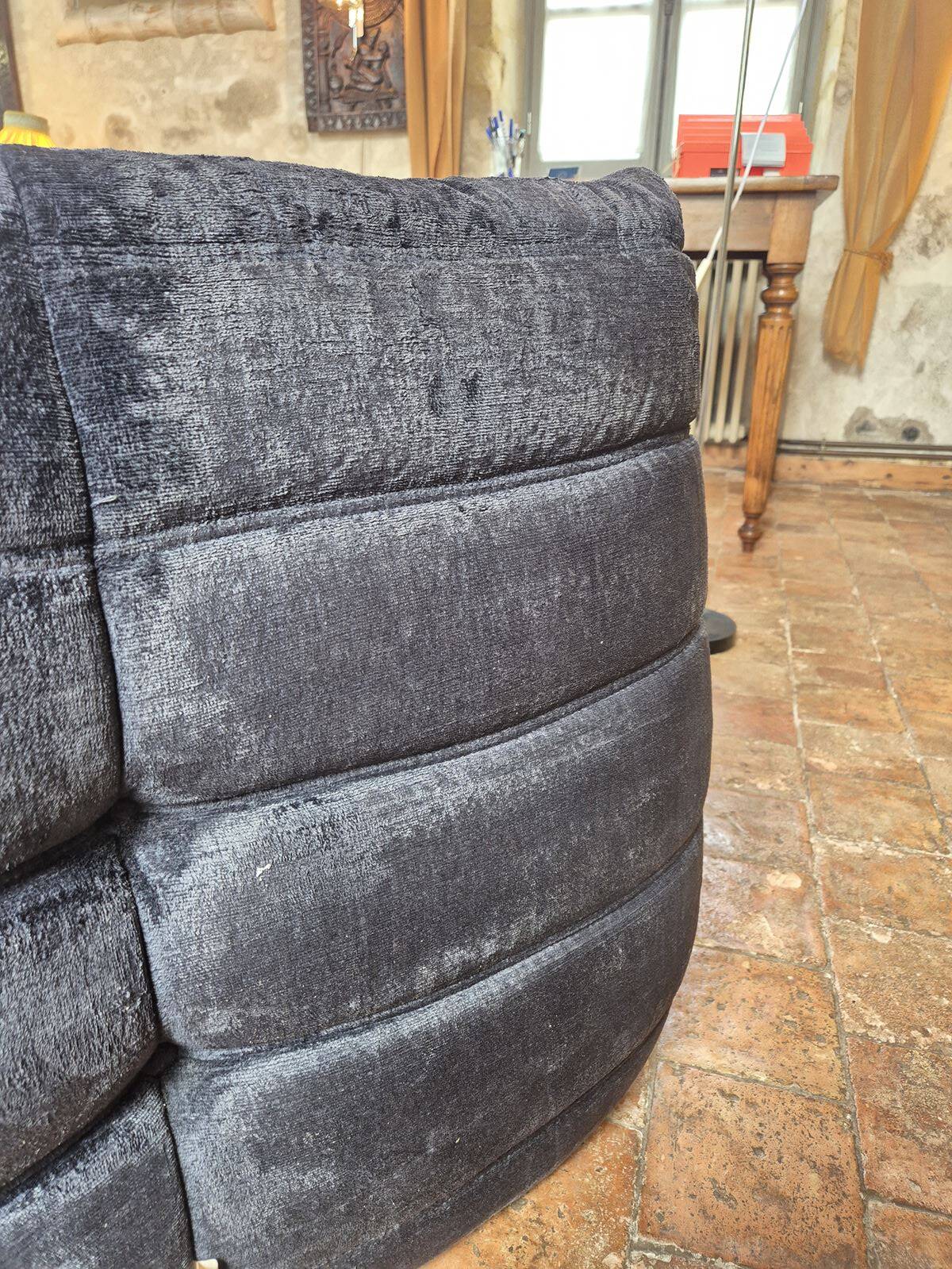 Togo sofa by Ligne Roset and its pouf from the 1970s.