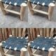 Set of four traditional moroccan stools in black leather and raw wood