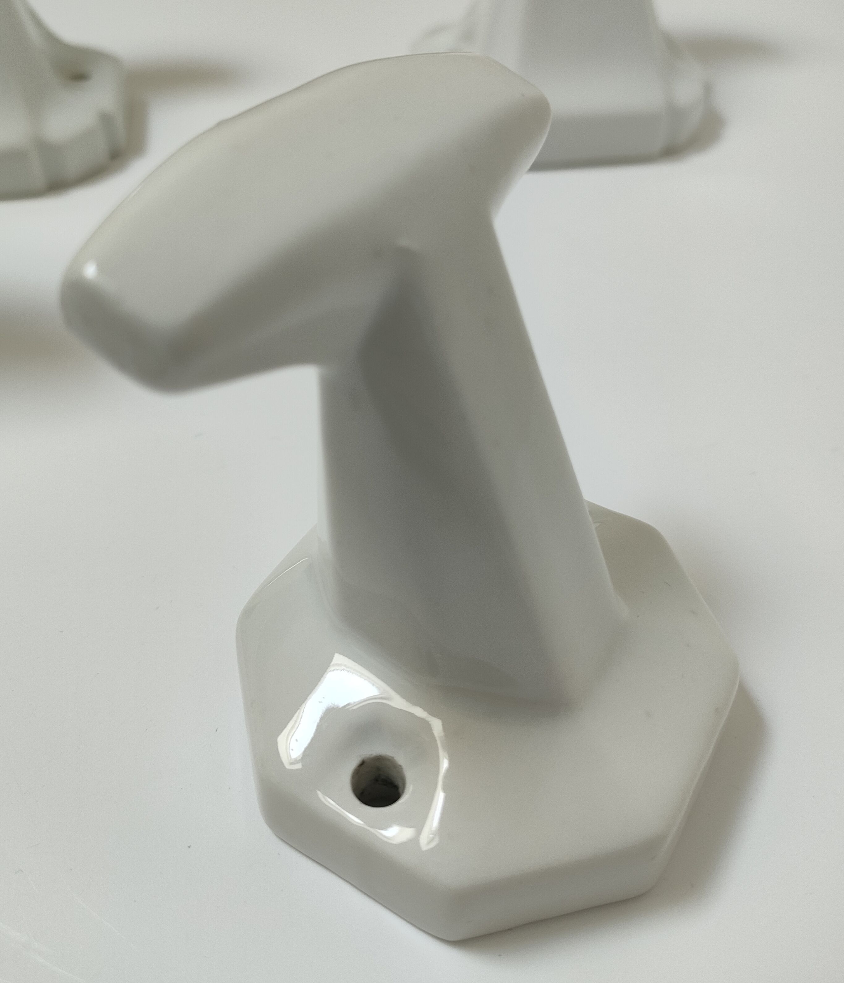 Five art deco white porcelain hooks