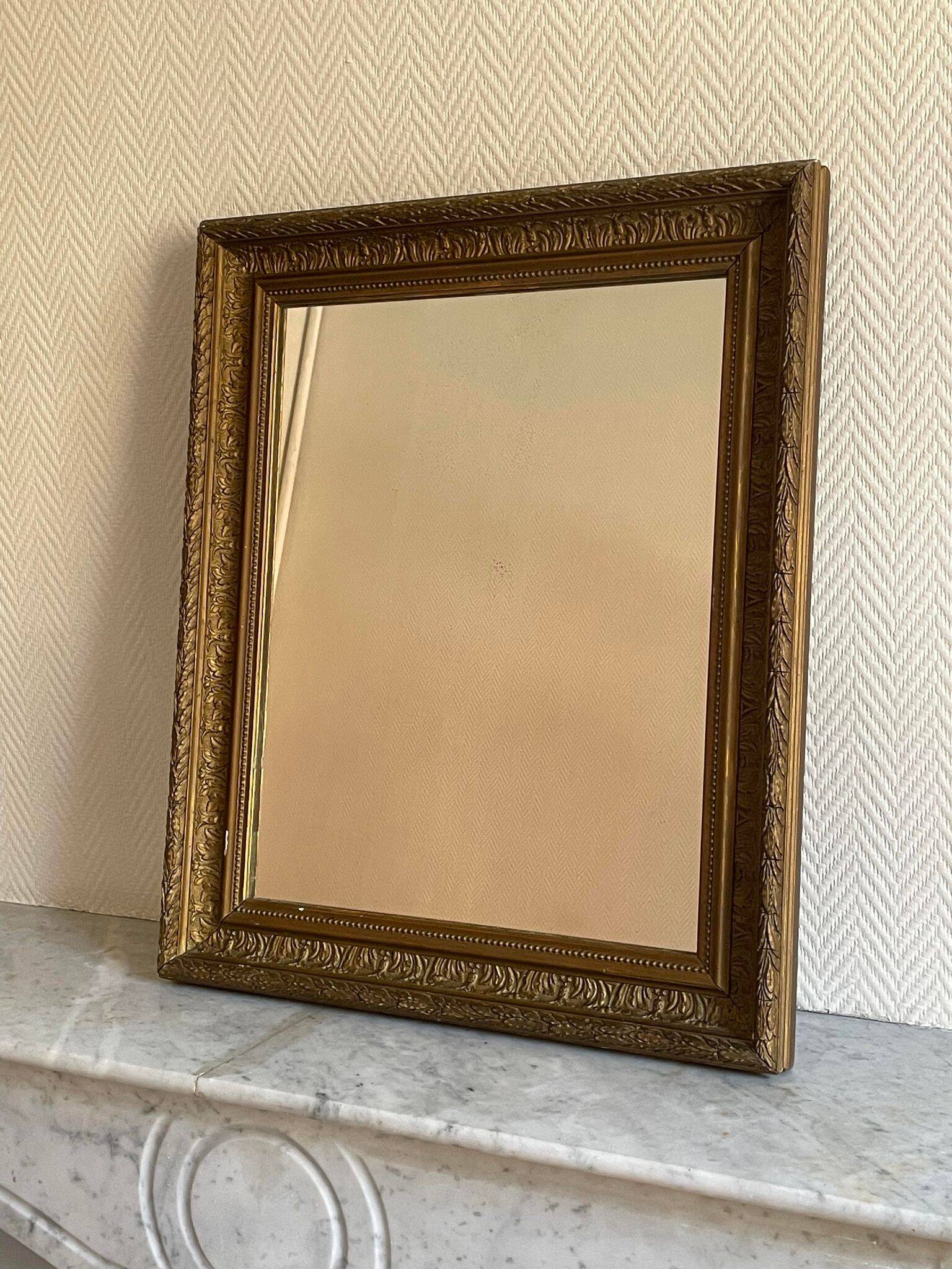 Old mirror with golden wooden frame