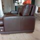 Two brown leather Crozatier two-and-a-half-seater sofas.