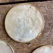 Lot of mother-of-pearl aperitif items, 7 coasters and a dish.