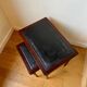 Dark wood and black leather tables