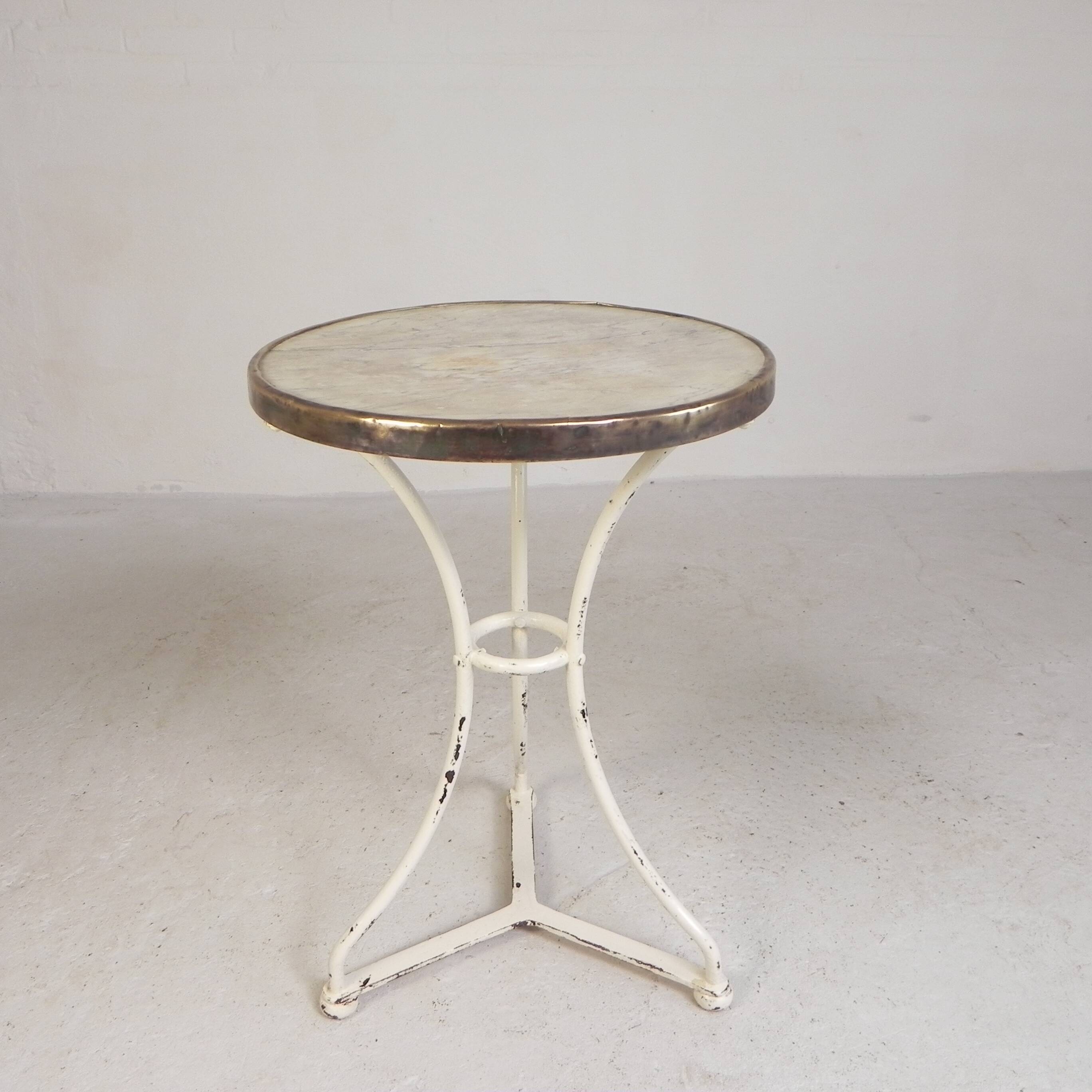 Bistro table with a marble top and brass edging, early 20th century.