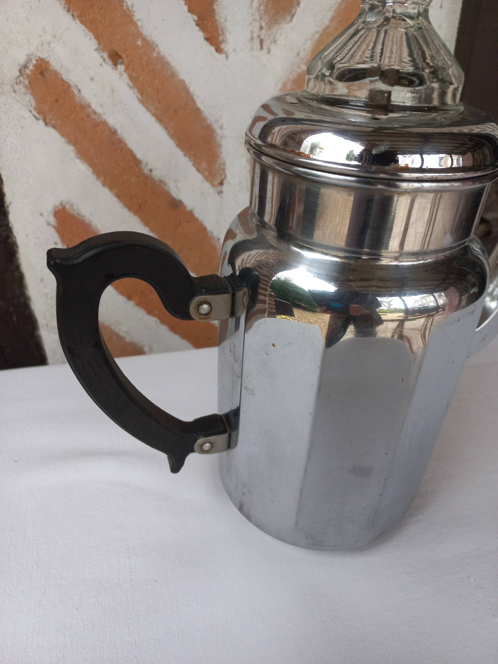 Silver metal coffee maker with glass cap