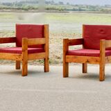 Pair of pine fireside chairs, France, 1960s, "raspberry" cushions