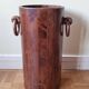 Art Deco umbrella stand in walnut with staves and ring handles, 1930.