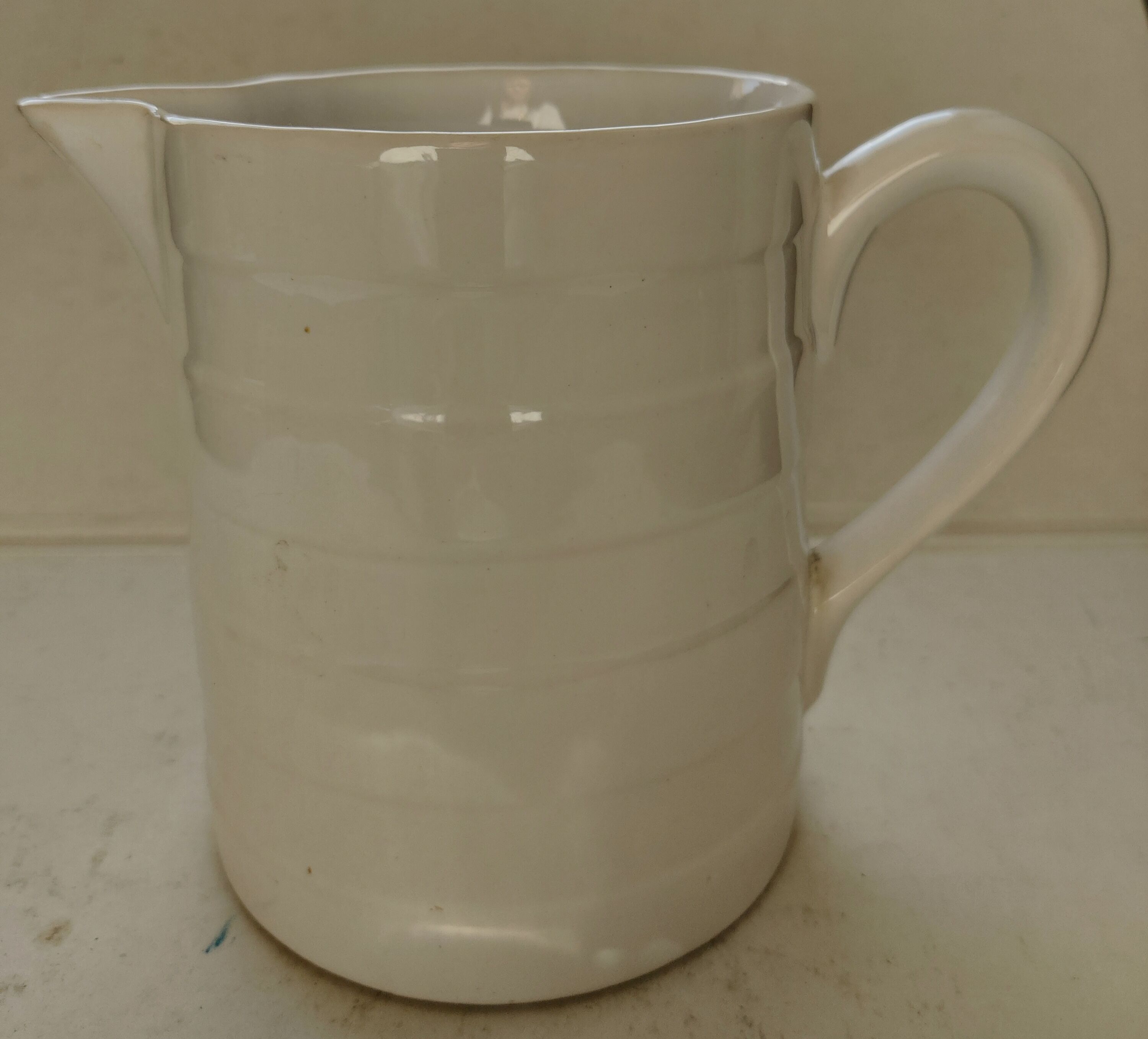 Antique white ceramic pitcher