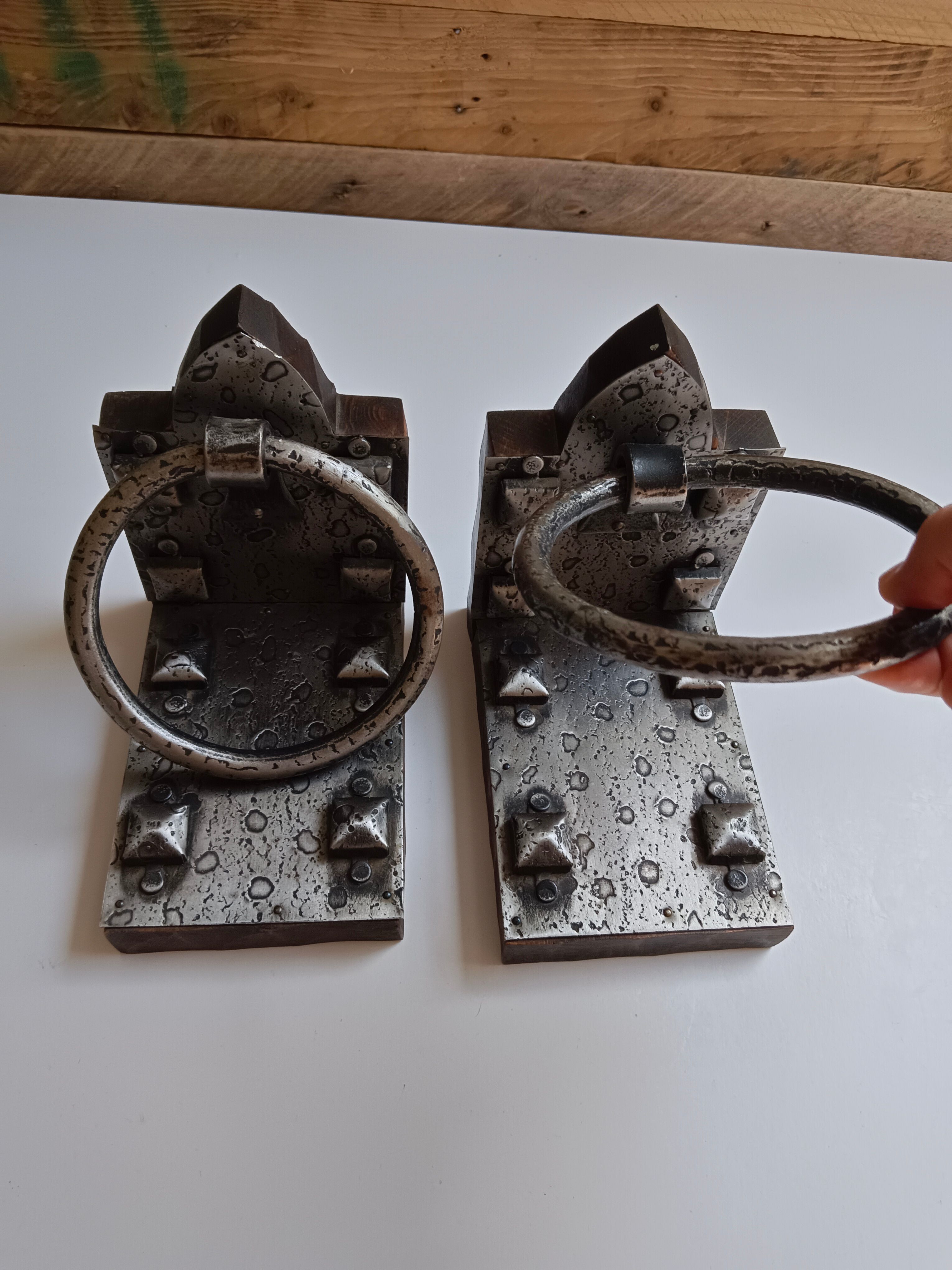 Medieval-style bookends, antique door handle.