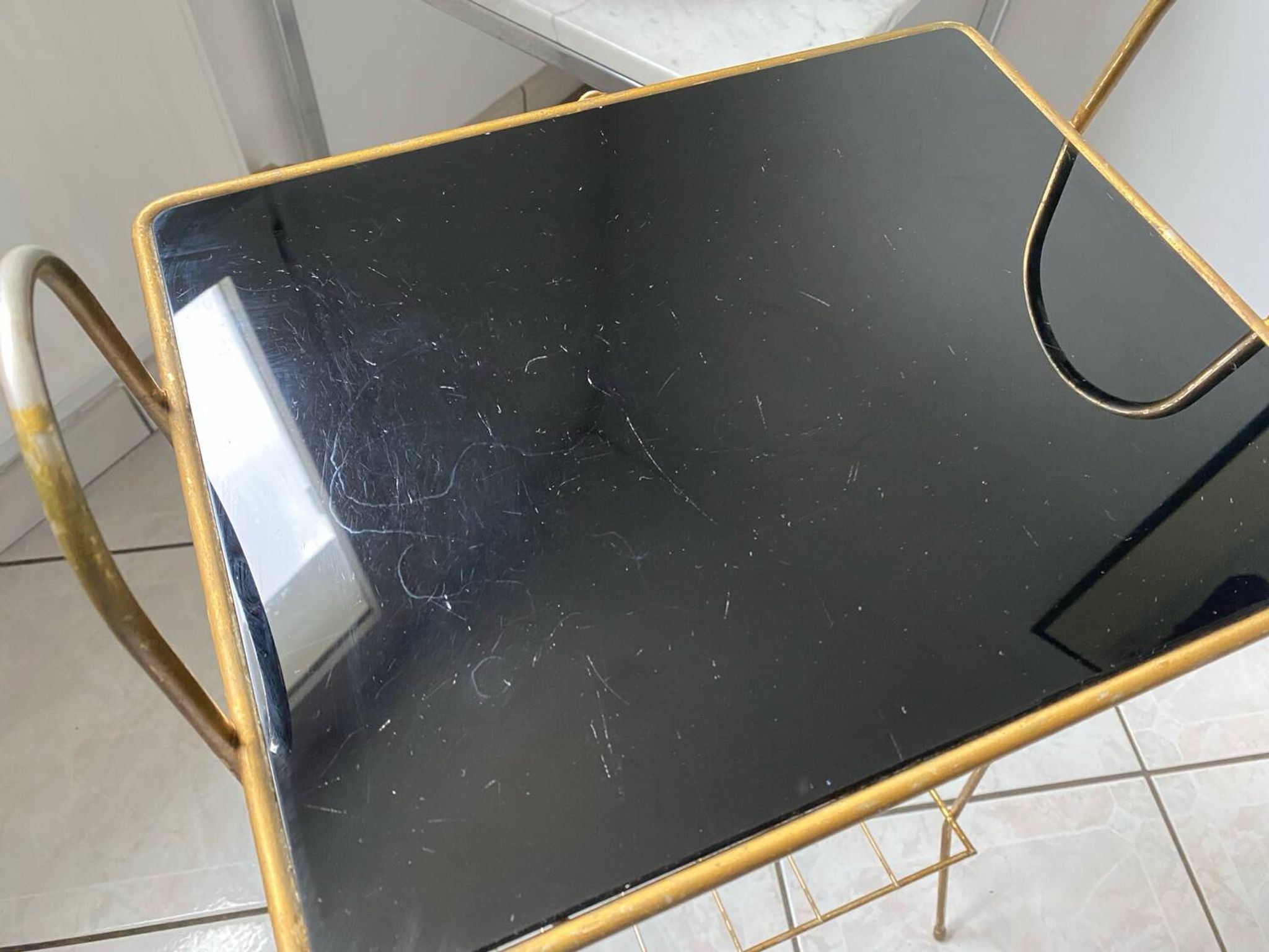 Vintage 1960s brass and smoked glass side table with magazine holder.