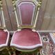 Louis XVI dining room table set with painted wood, gold accents, and pink velvet.