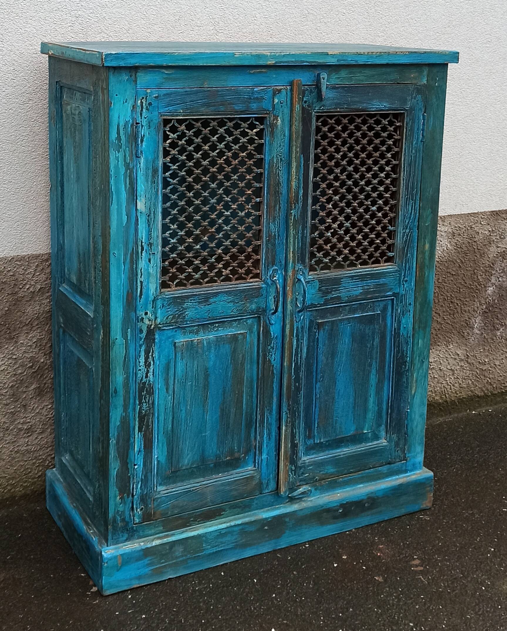 Old wooden cabinet with doors with grille
