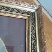 Old photo portrait framed in wood and stucco