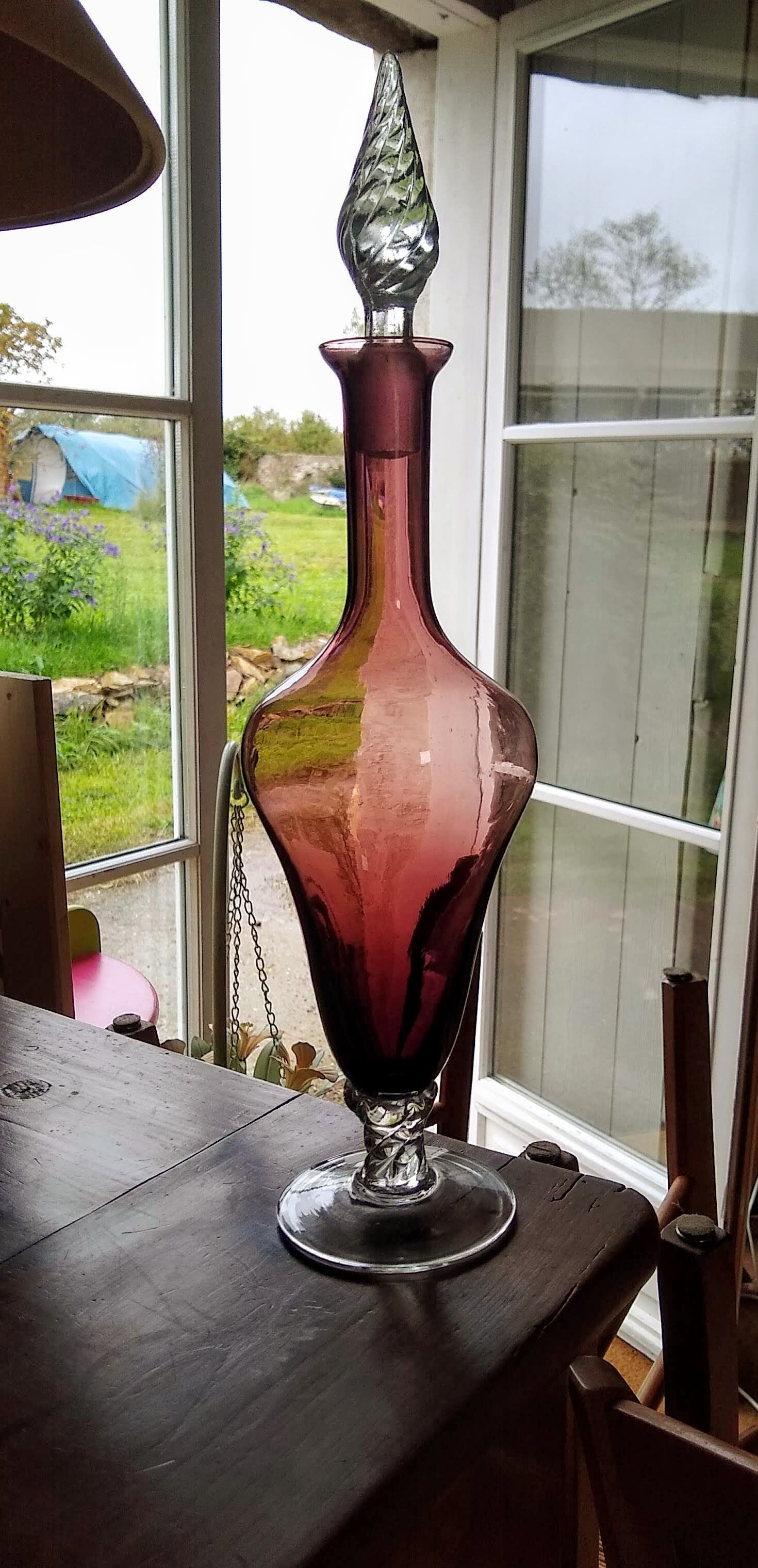 Purple-colored liquor-blown glass decanter with carved foot
