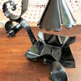 Handcrafted black wrought iron candle holder with its vintage extinguisher