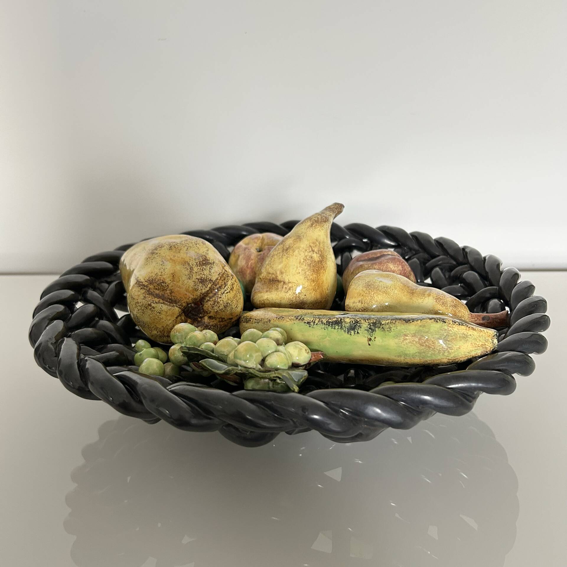 Large woven bowl and trompe l'œil fruits