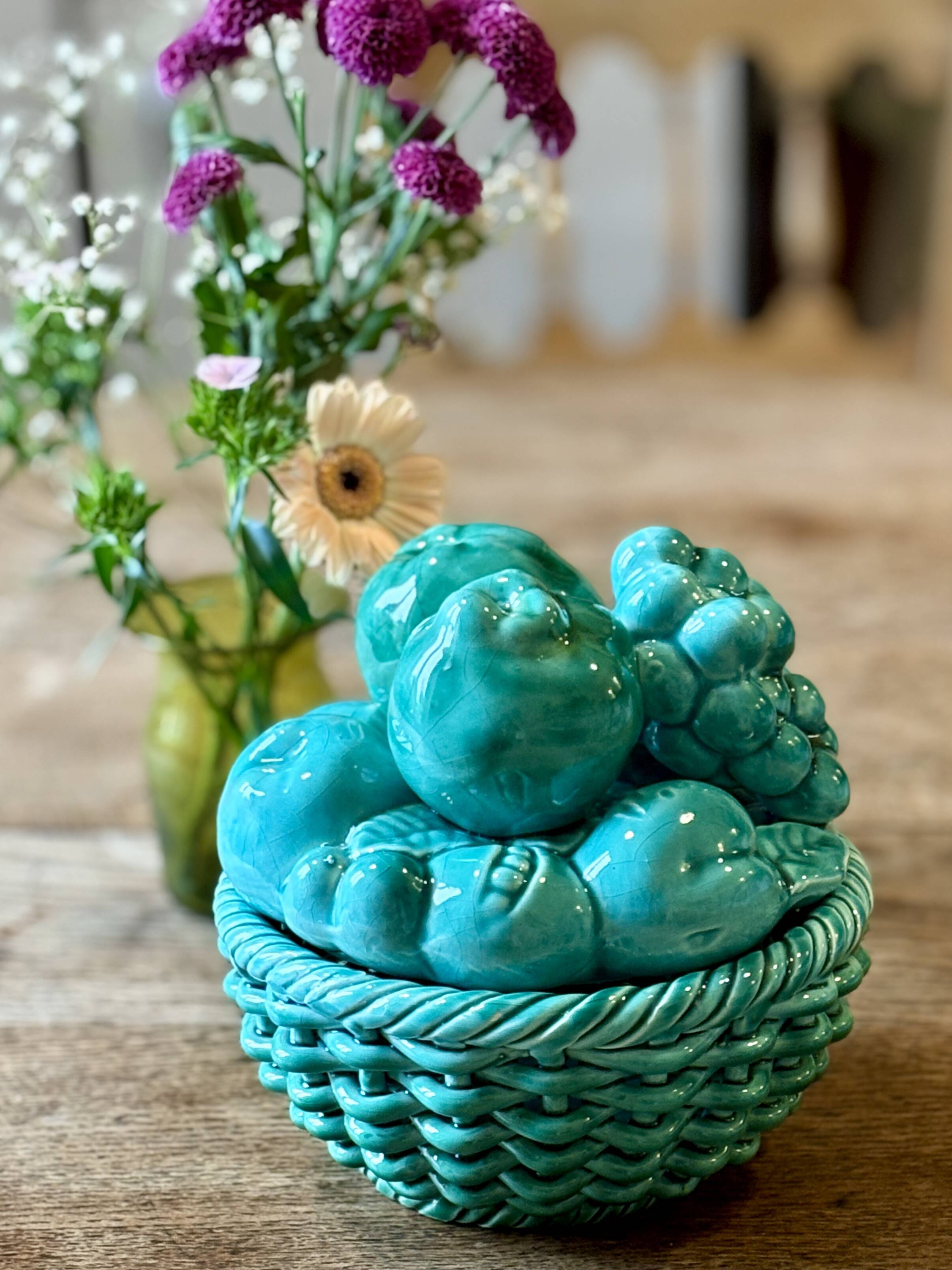 Vintage green earthenware plate/basket with fruit decorations.