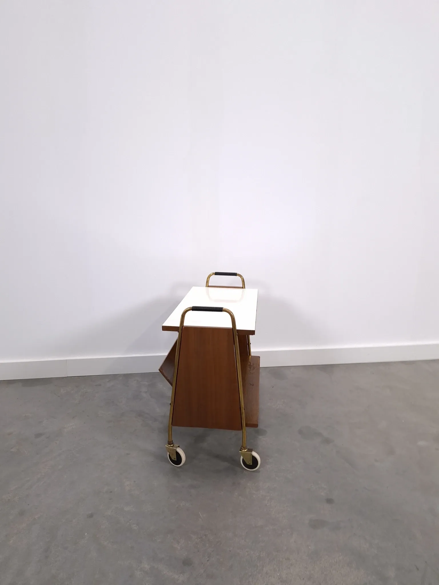 Vintage 1950s side table with a reading basket, formica top, teak wood.