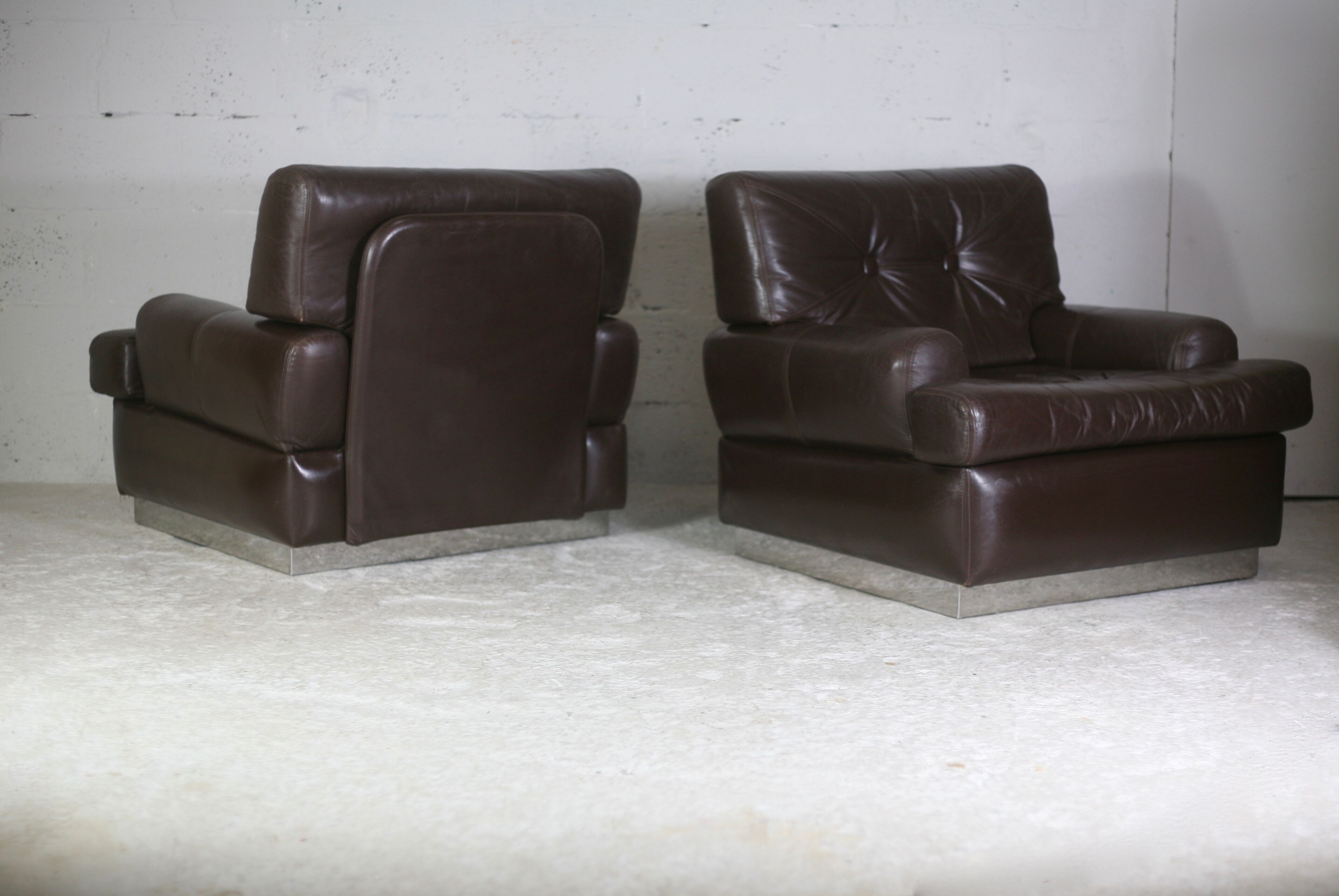 Pair of armchairs brown leather base stainless steel, France, circa 1970