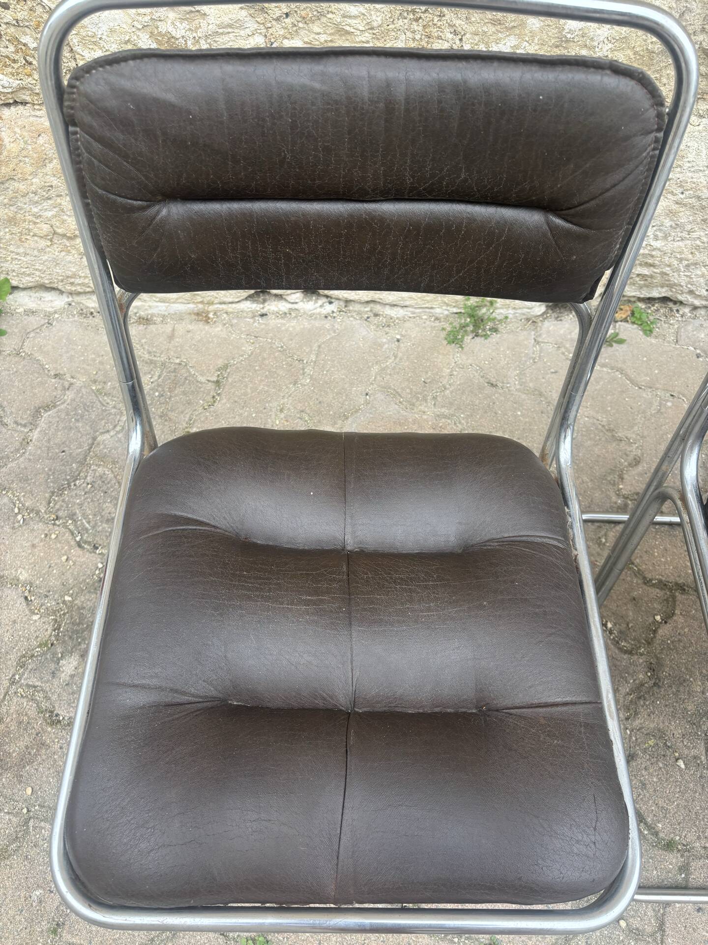 Four vintage chairs from the 1960s and 1970s, chrome with faux leather.
