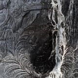 huge old fireplace plate has decoration of angels, crown and fleurs-de-lis