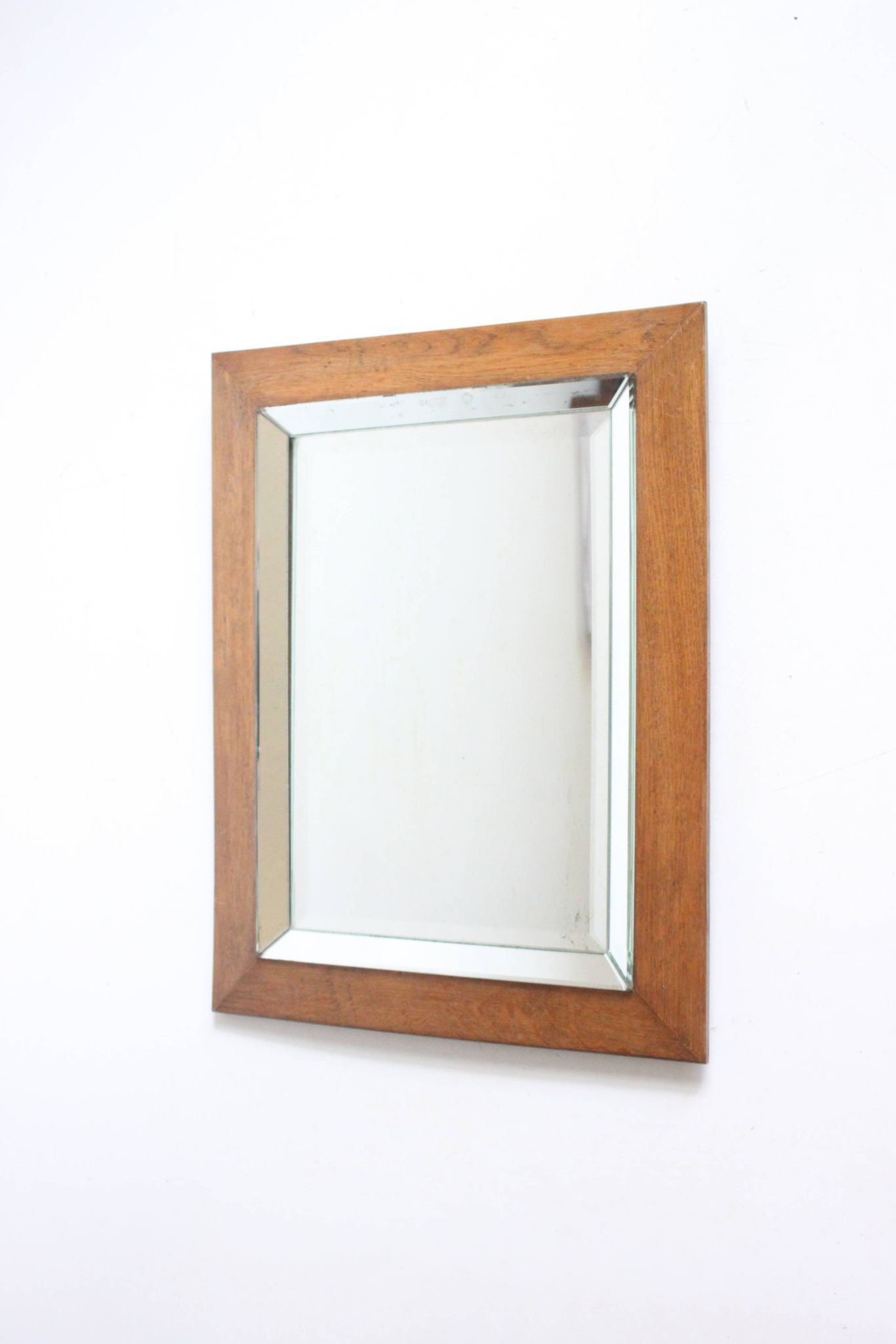 Art deco beveled mirror in an oak frame, 1940s.