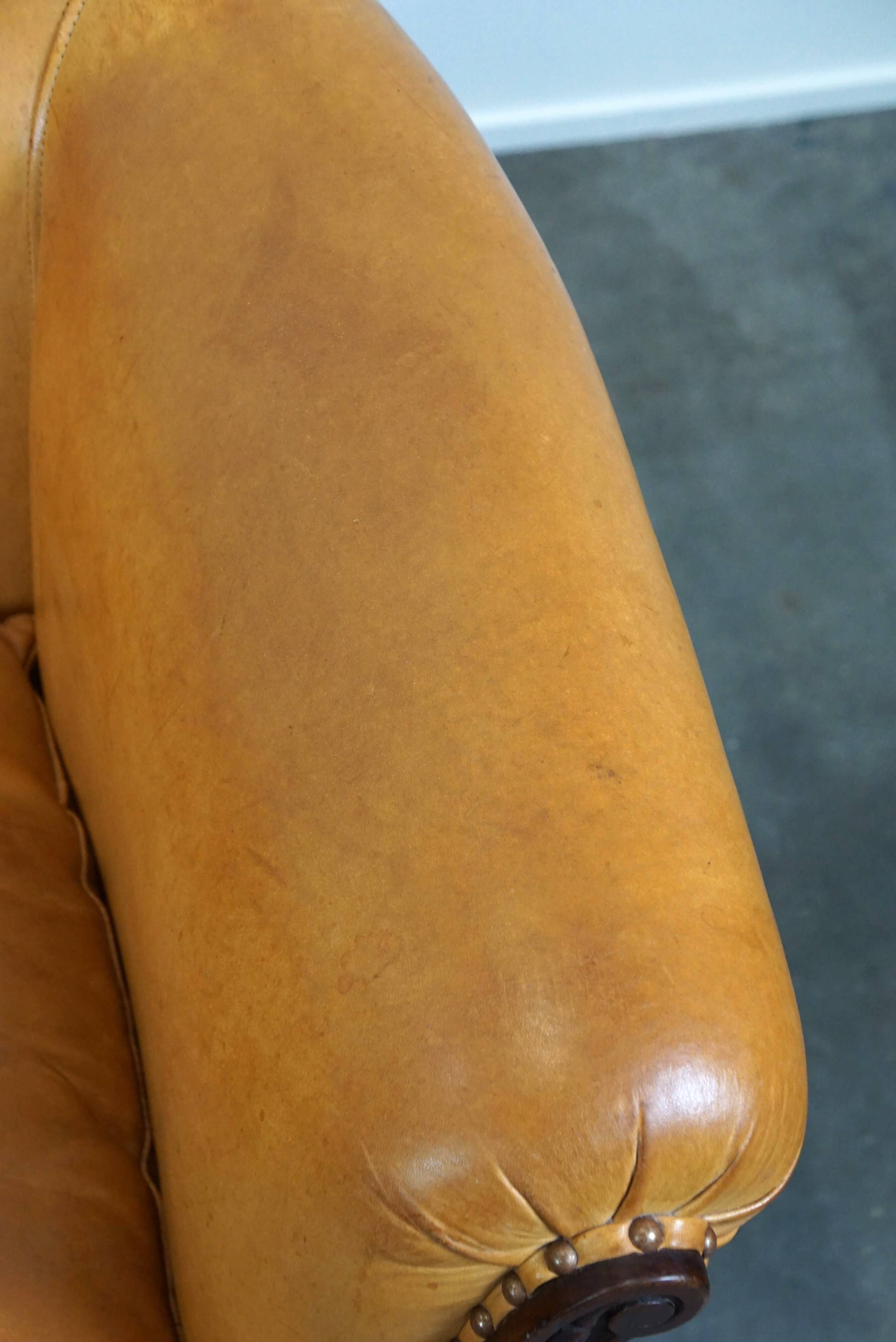 Unique old set of 2 club armchairs and a couch in cognac-colored leather with wheels