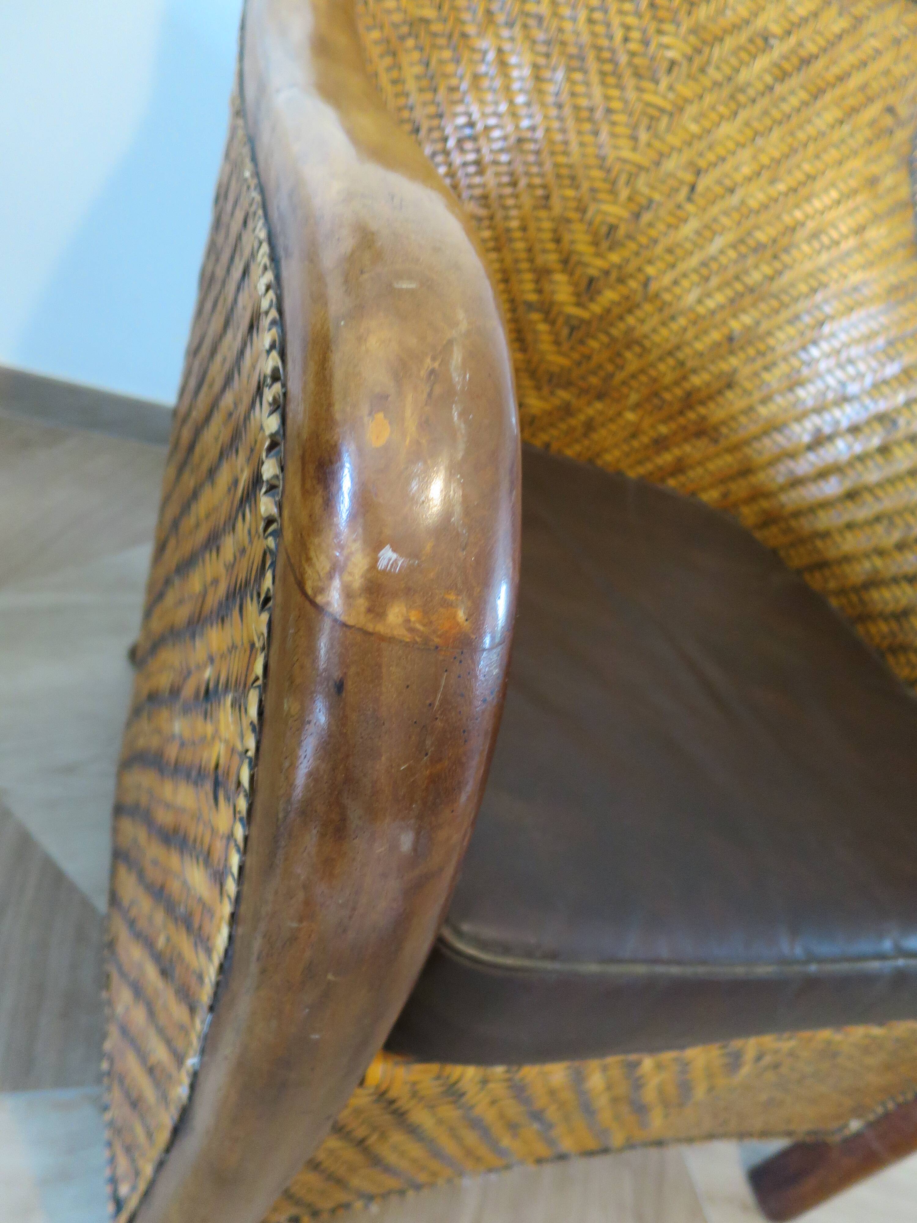 Colonial style armchair in woven rattan and exotic wood