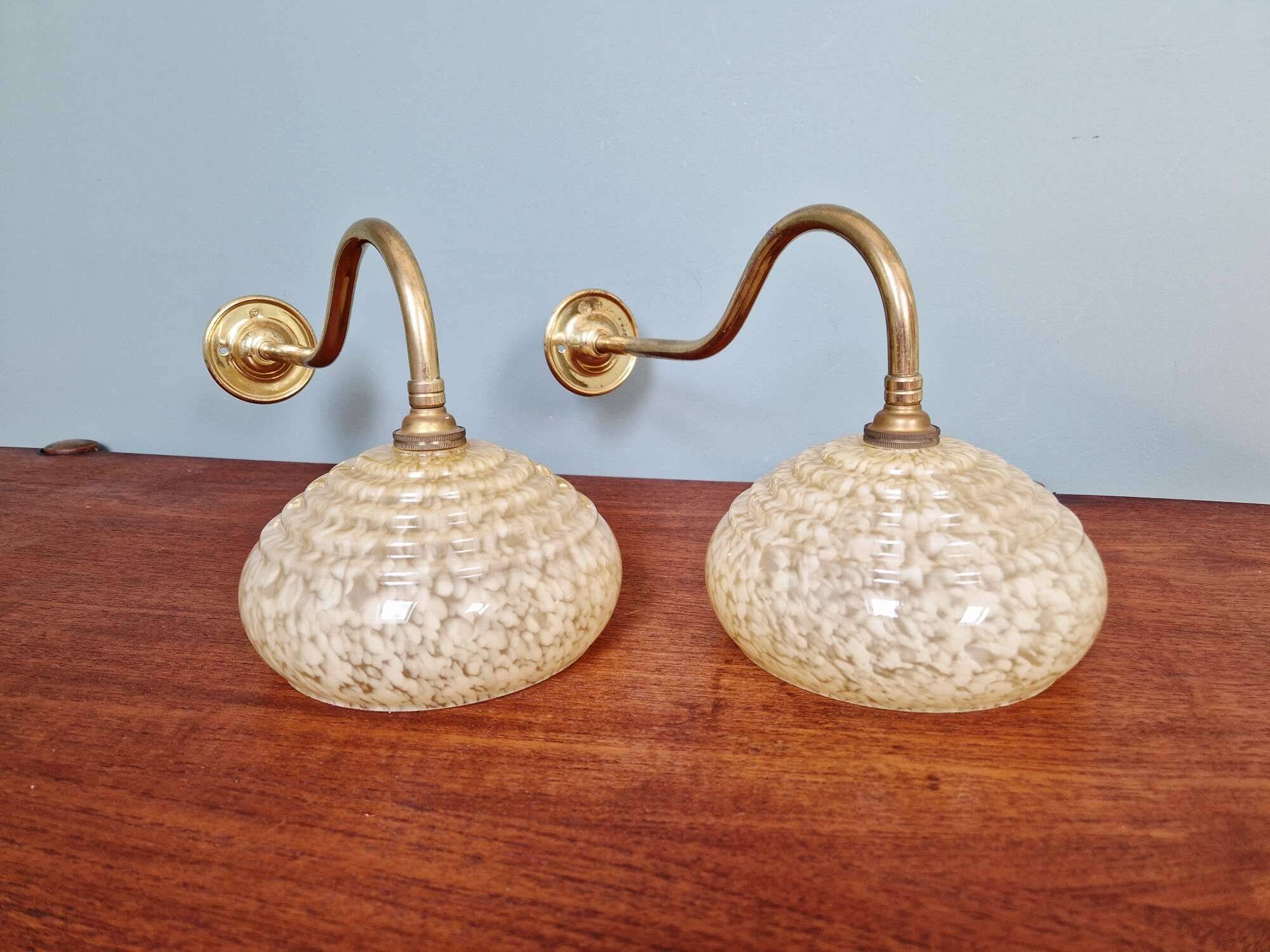 Pair of brass and yellow/white speckled glass wall sconces