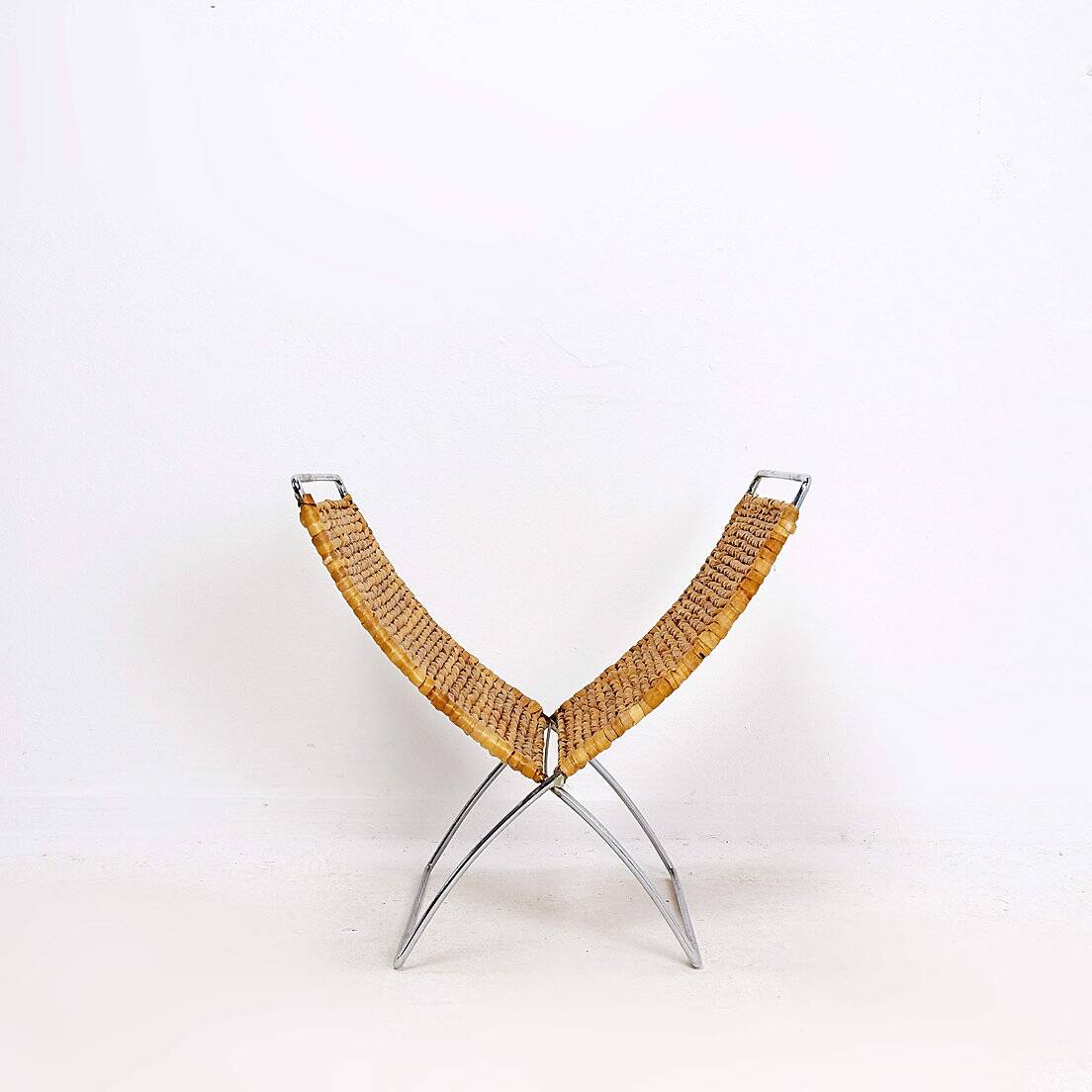 Chrome metal magazine rack with woven banana leaves